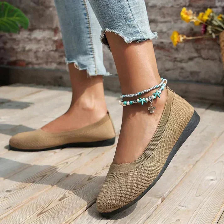 Stylish cream women's comfortable ballet flats, versatile for casual or travel wear.