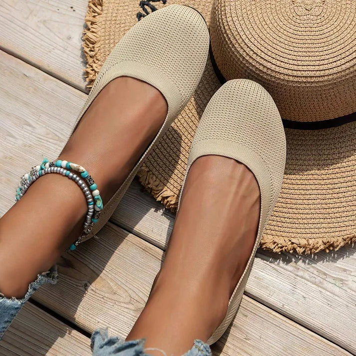 Navy blue women's slip-on ballet flats, offering comfortable all-day wear & versatile style.