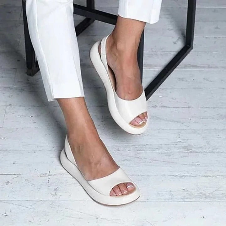 Women's comfortable slip-on sandals with open toe, cushioned footbed, perfect for summer.