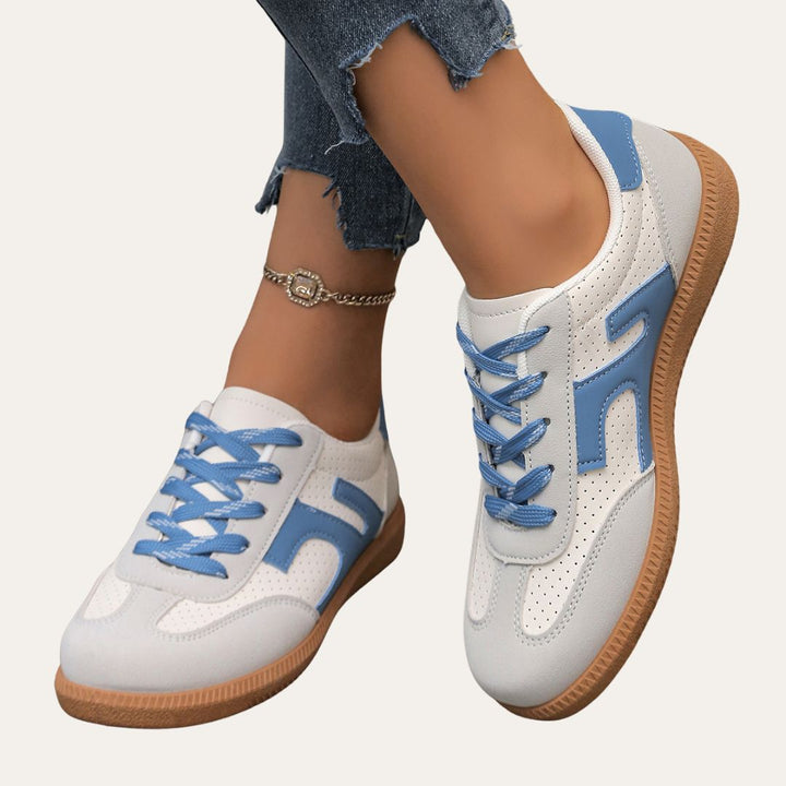 Fashionable women's low top sneakers in a neutral color, perfect for casual walking and comfort.