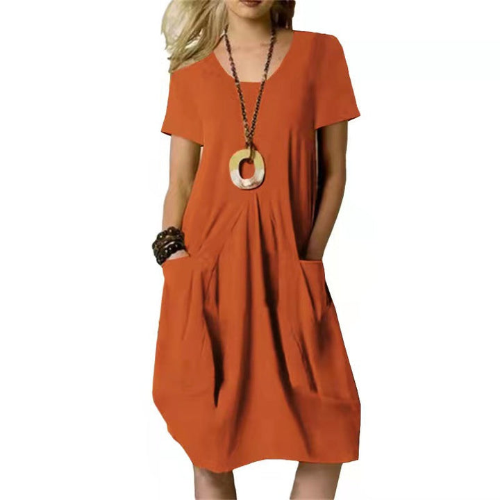 Solid color women's short sleeve swing dress for summer. Comfy, knee-length, with pockets for everyday casual wear.