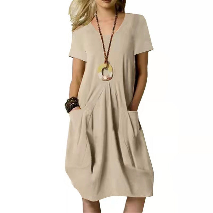 Stylish women's summer swing dress featuring functional pockets. Comfortable, short sleeve, and knee-length for casual wear.