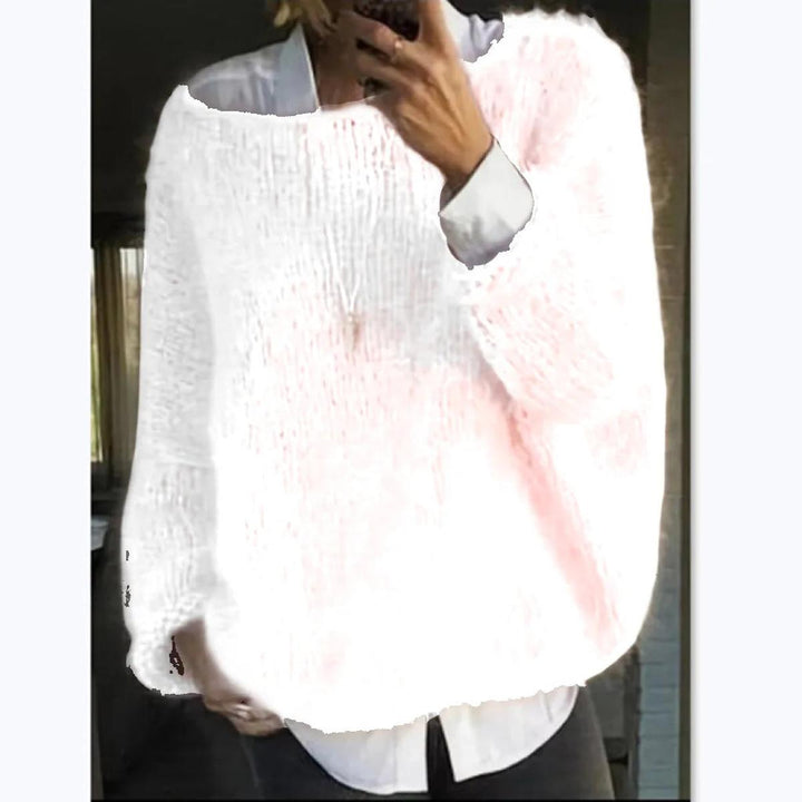 Close-up of the cozy knit texture on a women's long sleeve sweater