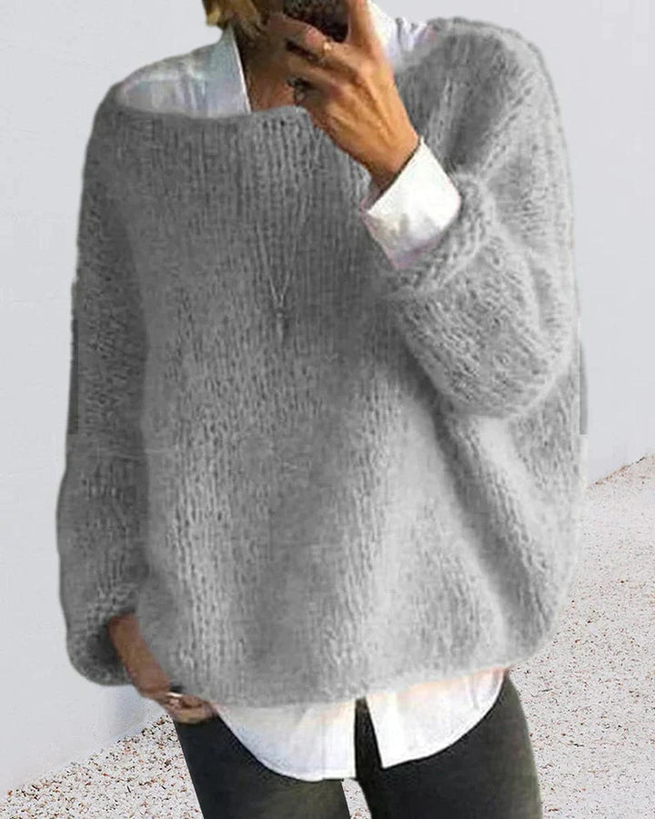Woman wearing a relaxed fit knit pullover sweater, ideal for winter apparel