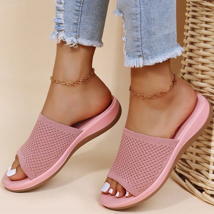 Women's cozy knit open-toe slippers, perfect for comfortable indoor wear. Breathable house shoes with a flat sole.