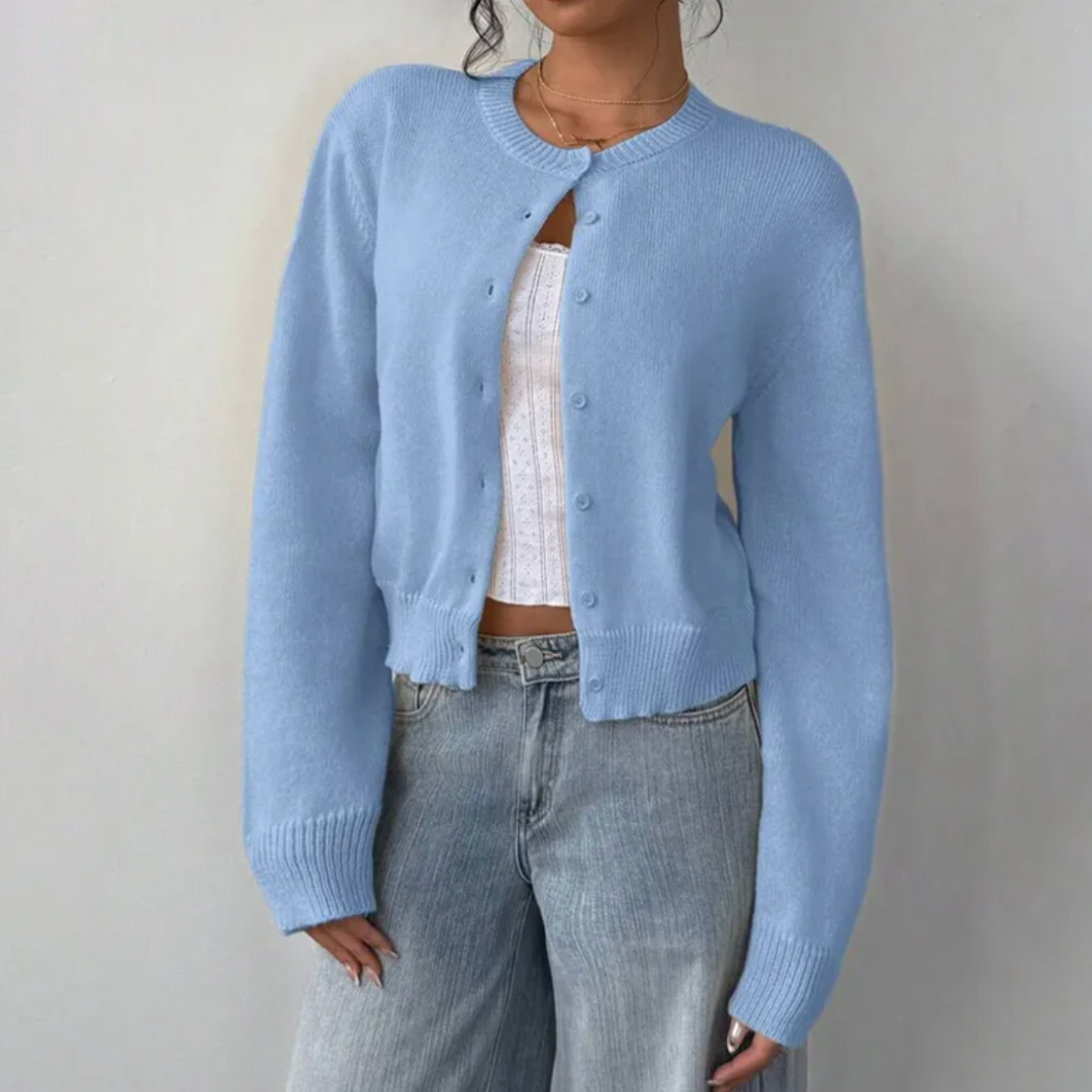 Back view of a woman wearing a blue cropped button cardigan, showing its comfortable fit.