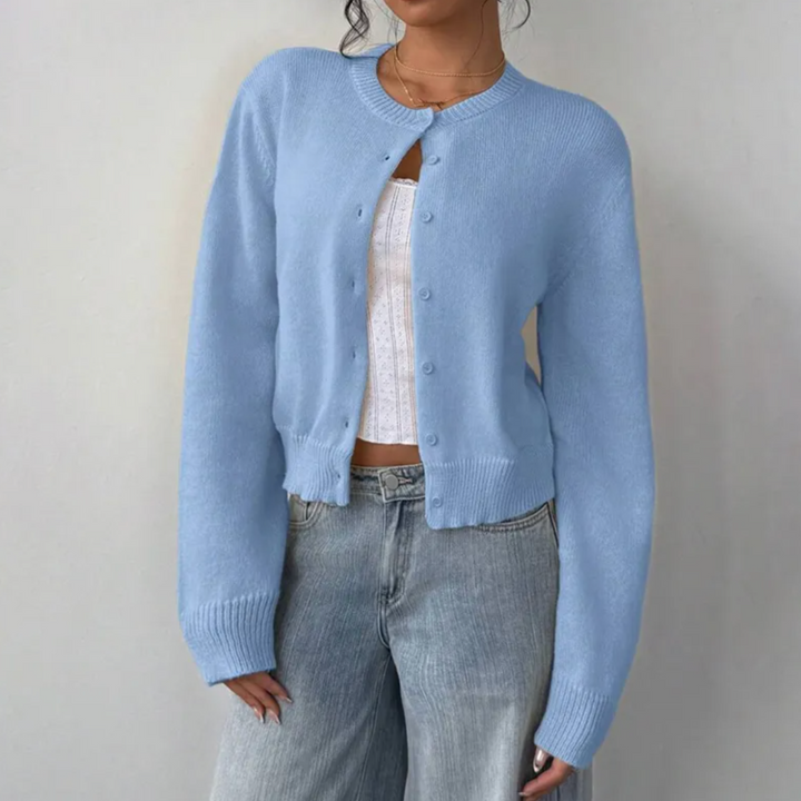Back view of a woman wearing a blue cropped button cardigan, showing its comfortable fit.