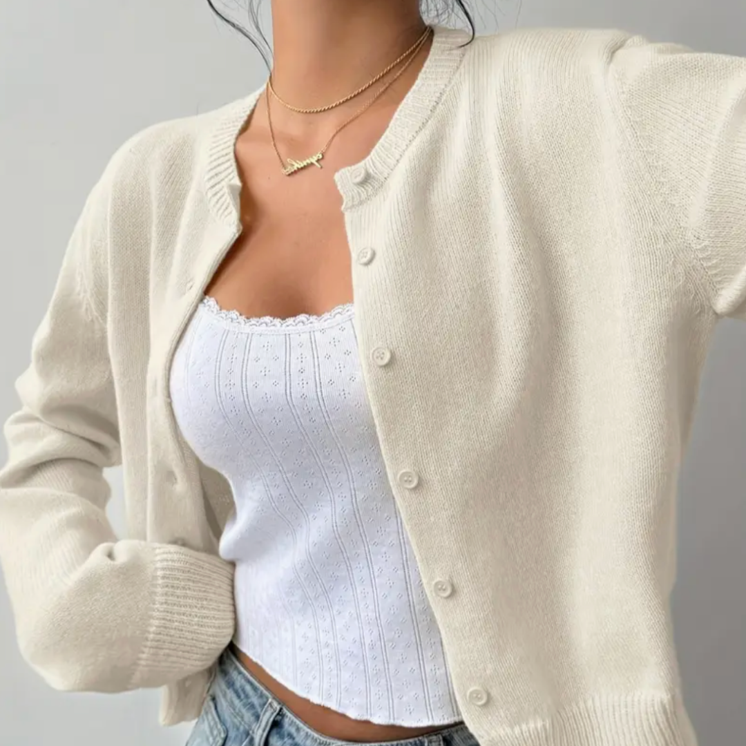 Close-up of a knitted texture on a women's cropped button cardigan, highlighting its quality.