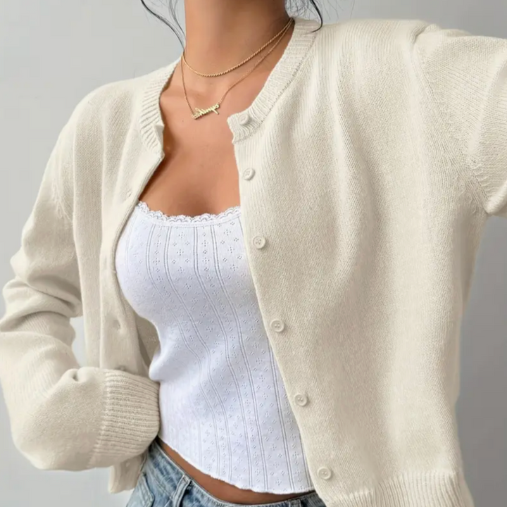 Close-up of a knitted texture on a women's cropped button cardigan, highlighting its quality.