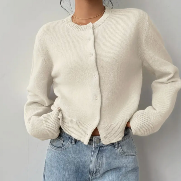 Model wearing a black cropped button cardigan, showcasing its flattering fit and casual elegance.