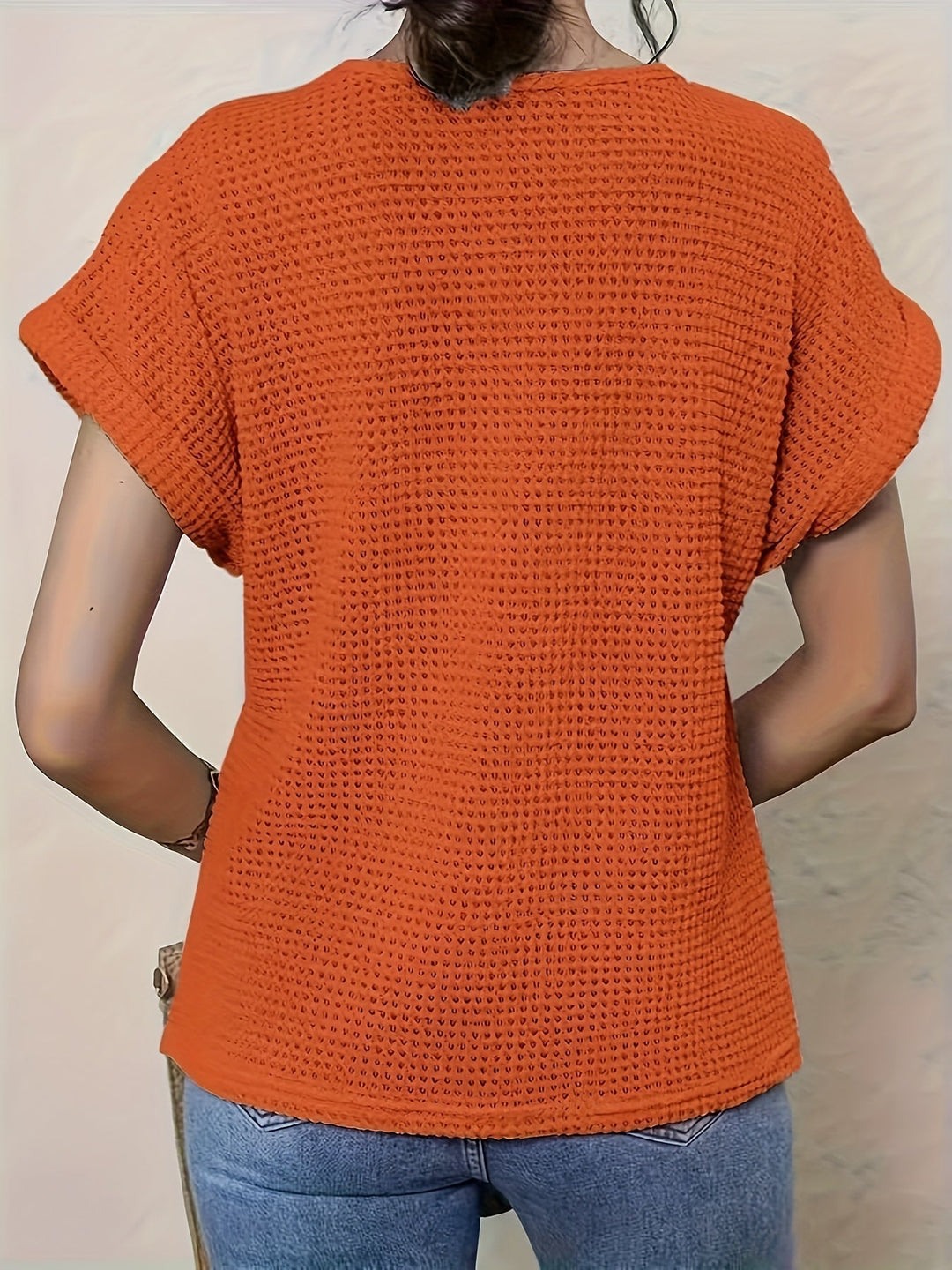 Round neck, short sleeve women's blouse with delicate crochet-style detailing. Versatile summer top.