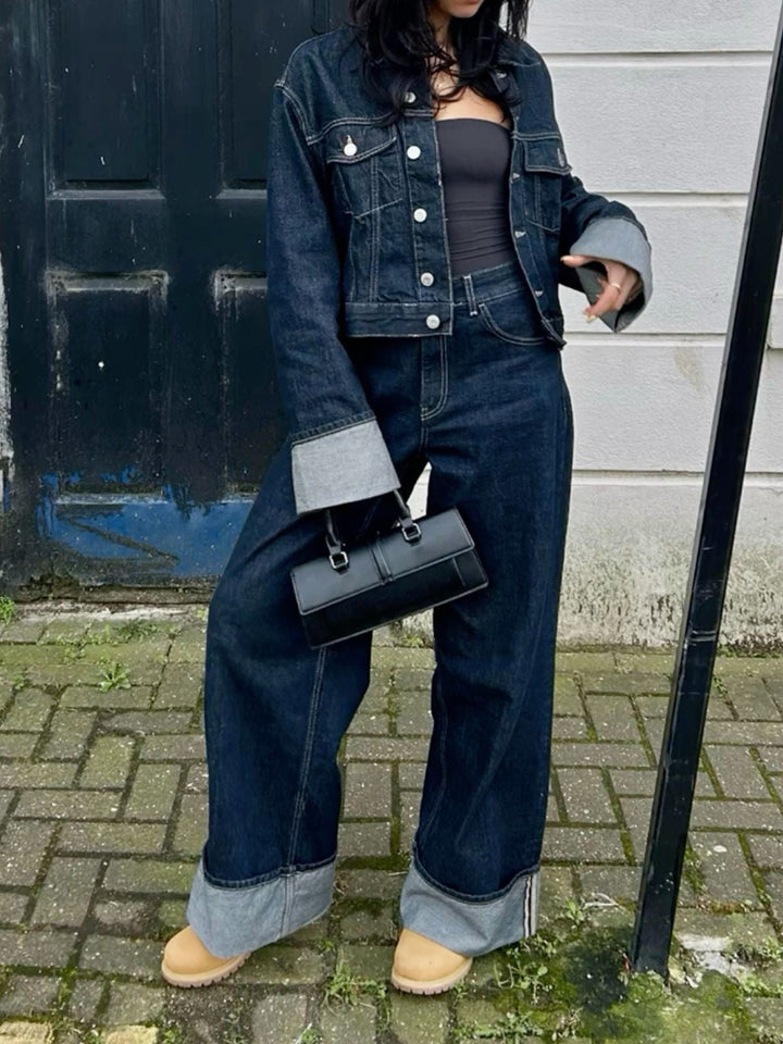 Close-up of the textured denim fabric of the women's cropped jacket and pants co-ord