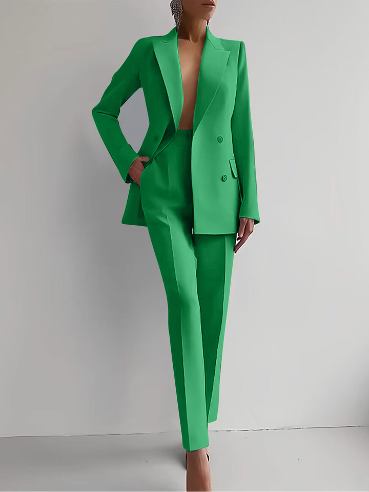 Green women's double-breasted blazer and slim trousers suit set. Versatile formal event attire.