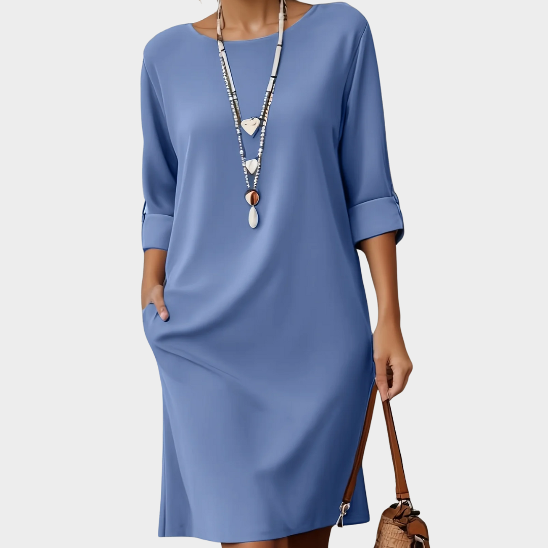 Elegant women's comfort work dress; rounded neck, three-quarter sleeves, professional look.