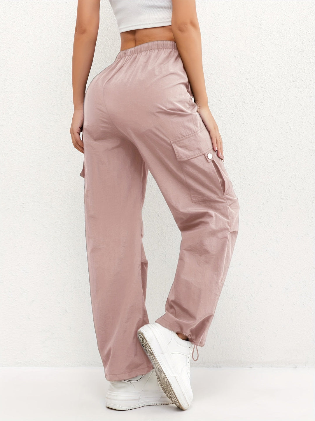 Women's drawstring cargo parachute pants. Relaxed fit, adjustable hem, and comfortable for casual street style.