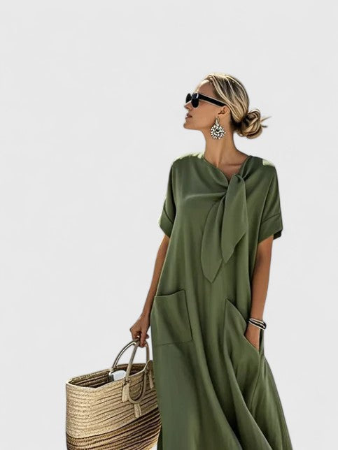 Comfortable women's flowy summer dress with practical pockets, great for travel, beach, or elegant evening outings.