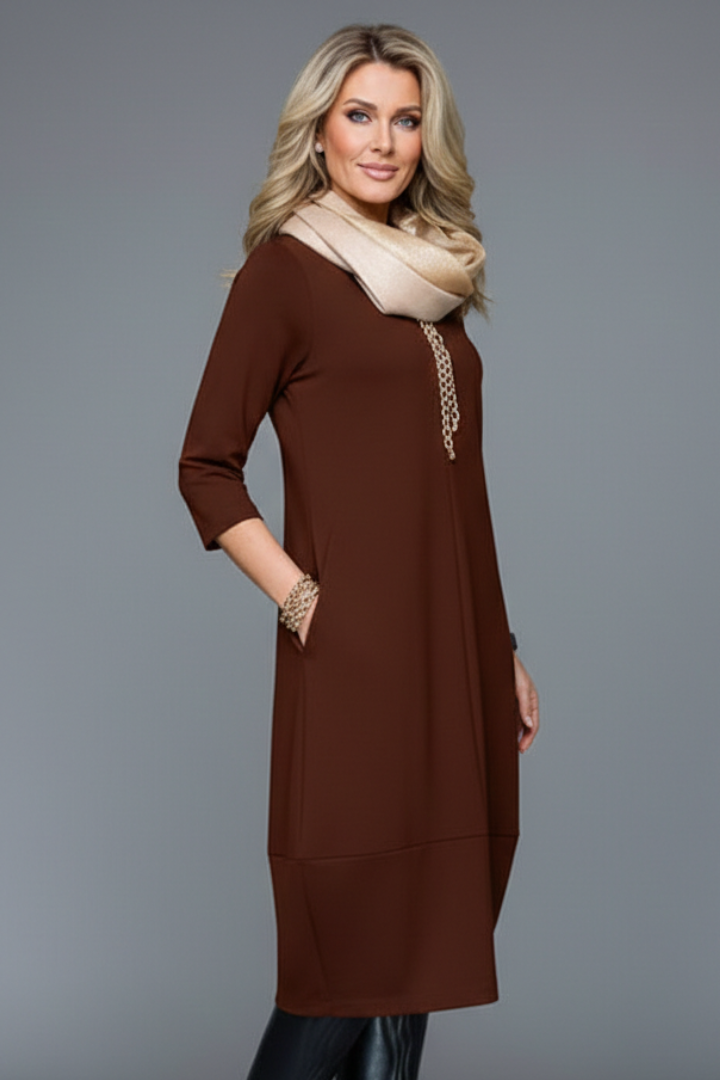 Women's casual midi dress showcasing a round neck, three-quarter sleeves, and convenient side pockets.