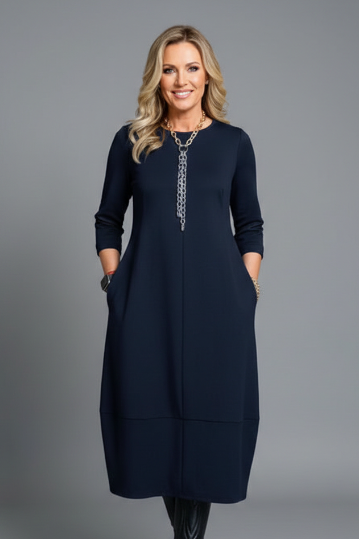 Comfortable, flowy women's midi dress with a flattering A-line silhouette, round neck, and practical pockets.