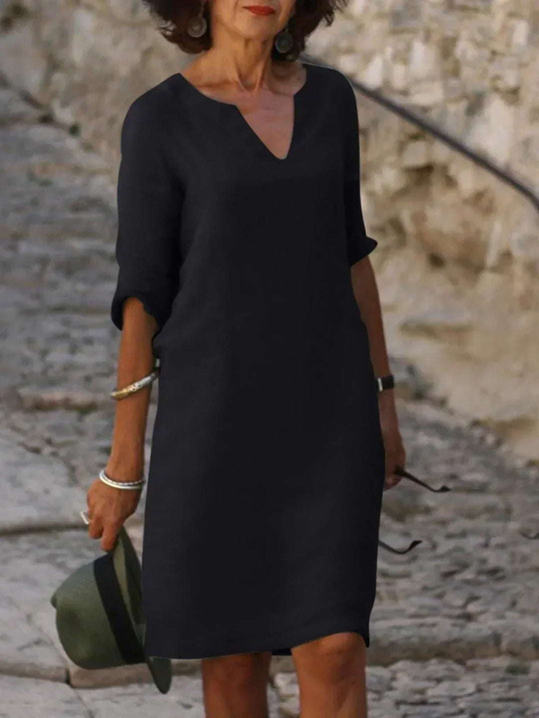 Women's effortless v-neck mini dress with 3/4 sleeves. Relaxed fit, perfect for casual everyday wear.