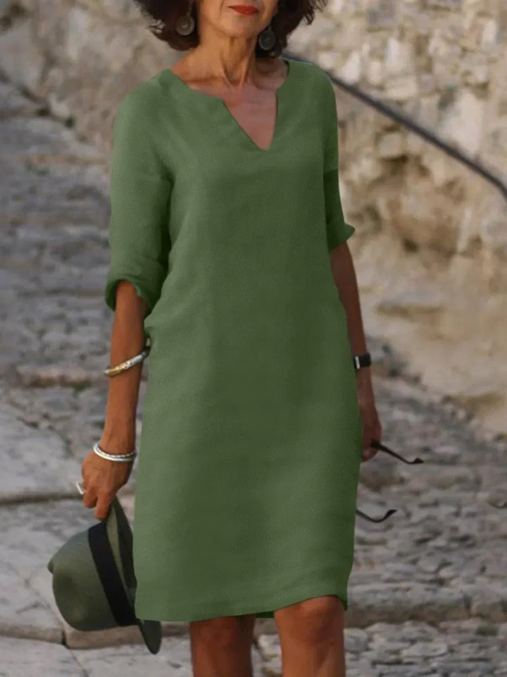 Spring fashion v-neck mini dress for women. 3/4 sleeve, relaxed fit, versatile for everyday style.