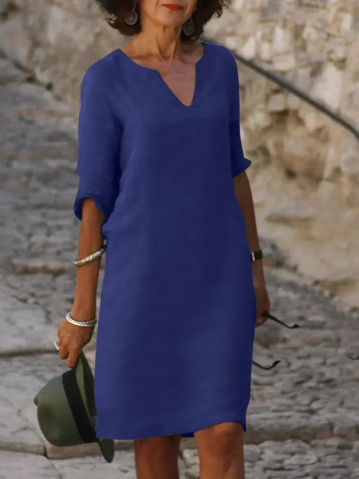 Women's casual v-neck mini dress with 3/4 sleeves. Comfortable, relaxed fit, short dress for spring.
