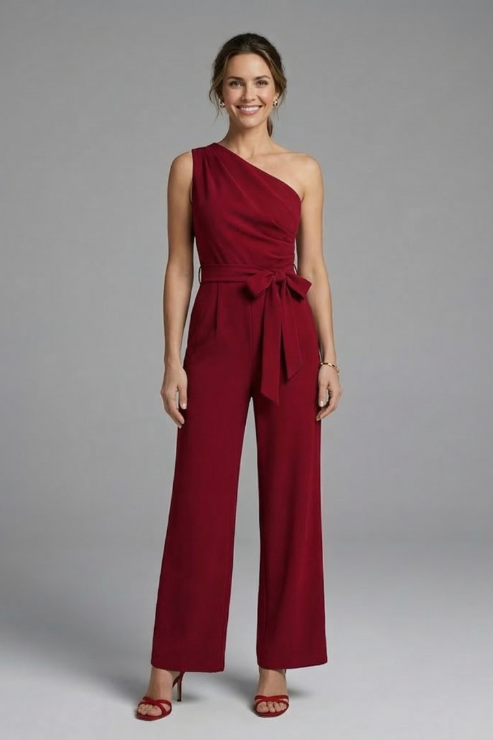 Modern fashion women's jumpsuit with a unique asymmetric neckline, wide legs, and a flattering waist belt.