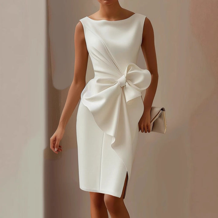 Women's elegant asymmetric sleeveless dress, perfect for cocktails or wedding guests. Features a chic bow detail.