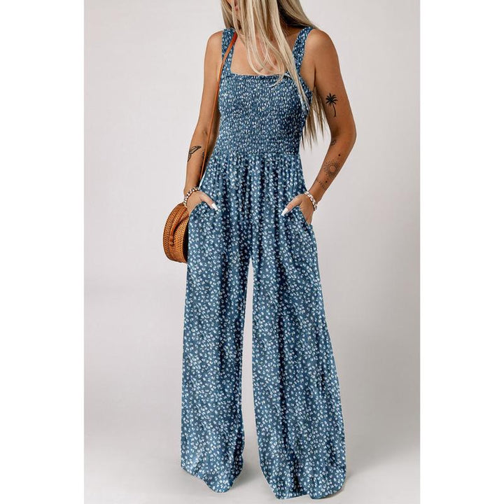 Model posing in an elegant floral wide-leg jumpsuit, emphasizing its versatile style.