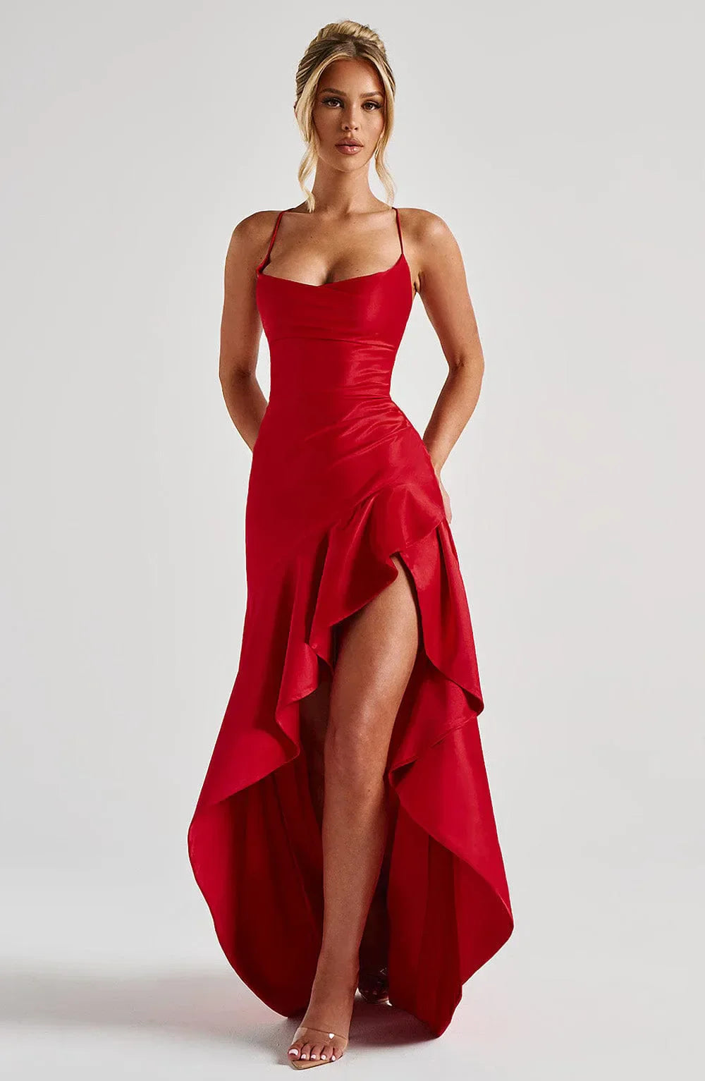 Chic women's long wedding guest dress with a high slit, open back, and elegant floor-length silhouette.