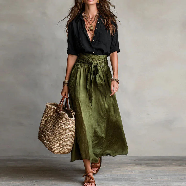Woman wearing a stylish linen blouse and midi skirt co-ord set, ideal for a relaxed summer day out.
