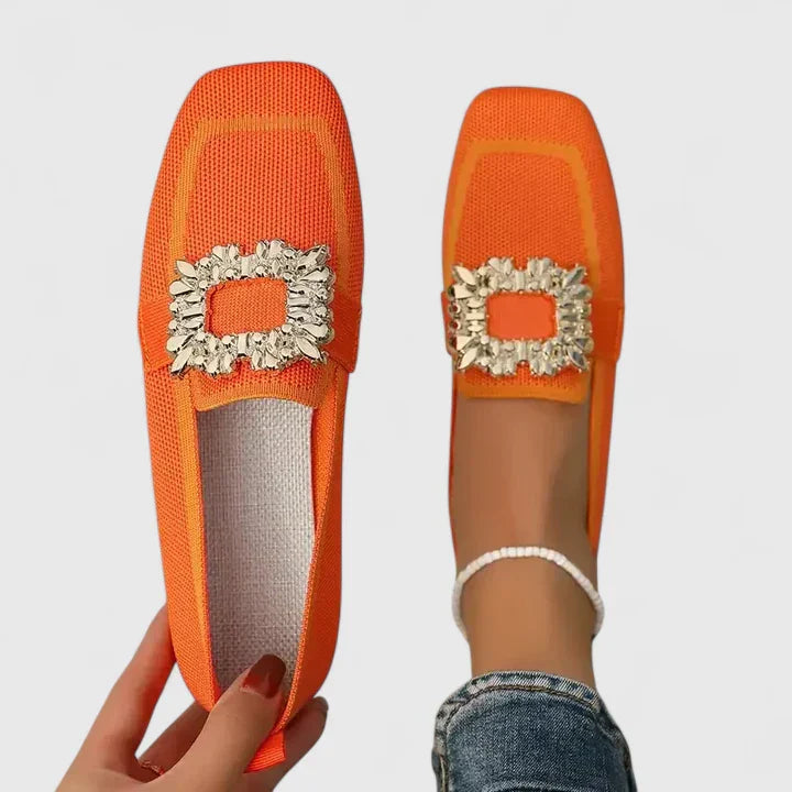 Close-up of embellishments on women's slip-on loafers, showcasing decorative detail