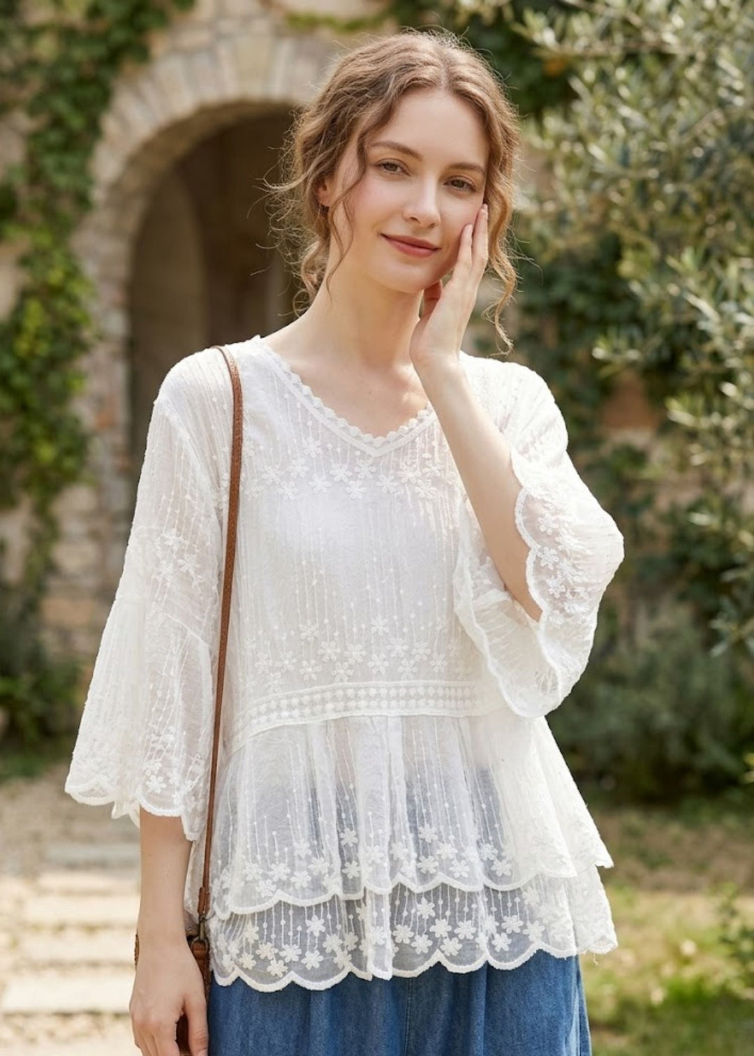 Women's embroidered blouse with elegant floral pattern, tiered lace hem, and comfortable half sleeves. Perfect for summer.