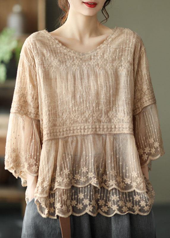 Bohemian-style women's blouse featuring delicate floral embroidery, a charming tiered lace hem, and relaxed half sleeves.
