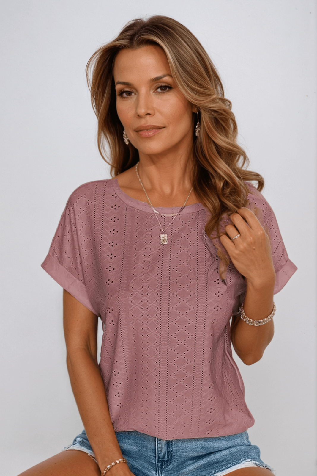 Pink eyelet short sleeve round neck top for women. Comfortable & stylish, great for everyday wear and summer outfits.