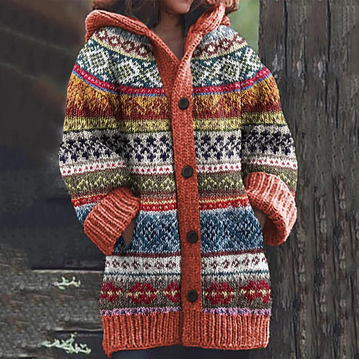 Woman wearing a cream Fair Isle hooded knit cardigan, styled casually for layered winter fashion.