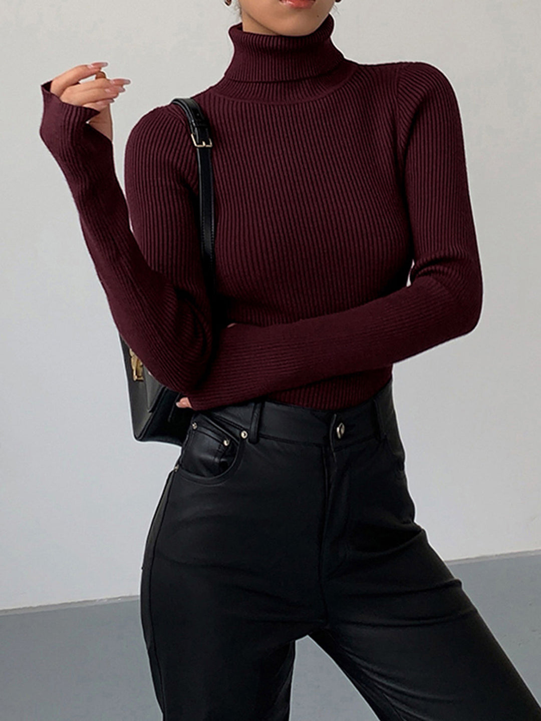 Women's fitted ribbed knit turtleneck sweater in a classic black, perfect for spring casual wear.