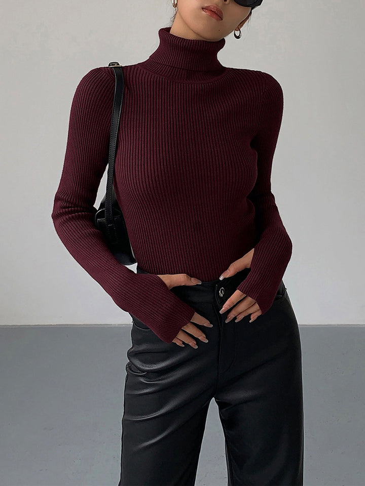 Close-up of the soft ribbed texture on a women's long sleeve turtleneck sweater, comfortable spring casual.