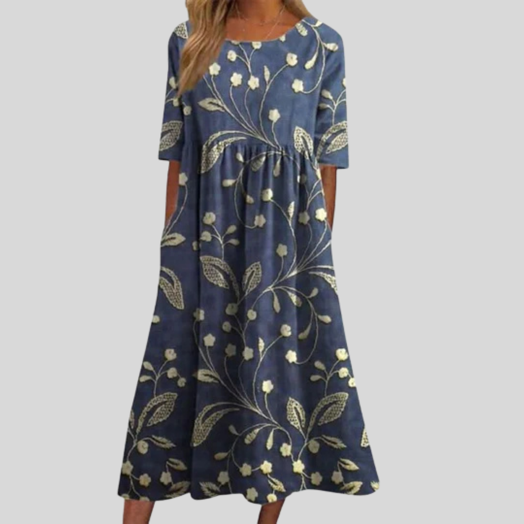 Women's flattering floral print empire waist midi dress with convenient pockets.