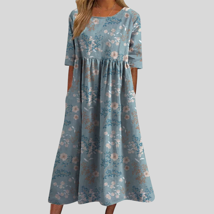 Comfortable & flowy women's floral midi dress with empire waist, three-quarter sleeves, and practical pockets.