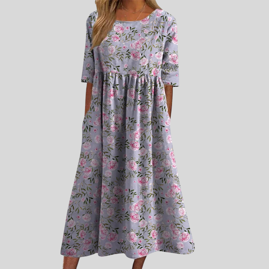 Stylish women's floral midi dress featuring a flattering empire waist, three-quarter sleeves, and pockets.