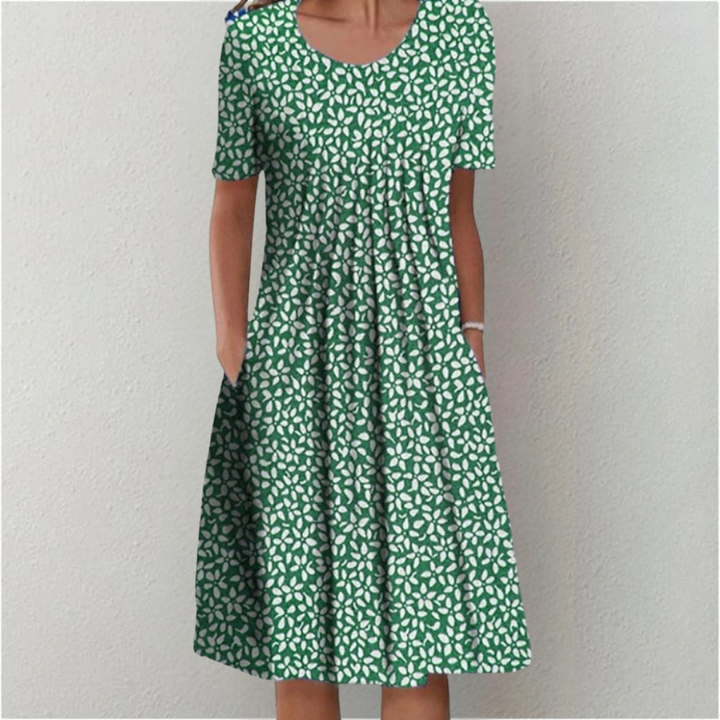 Model wearing a comfortable women's floral casual midi dress. Short sleeves, A-line cut, round neck & pockets.