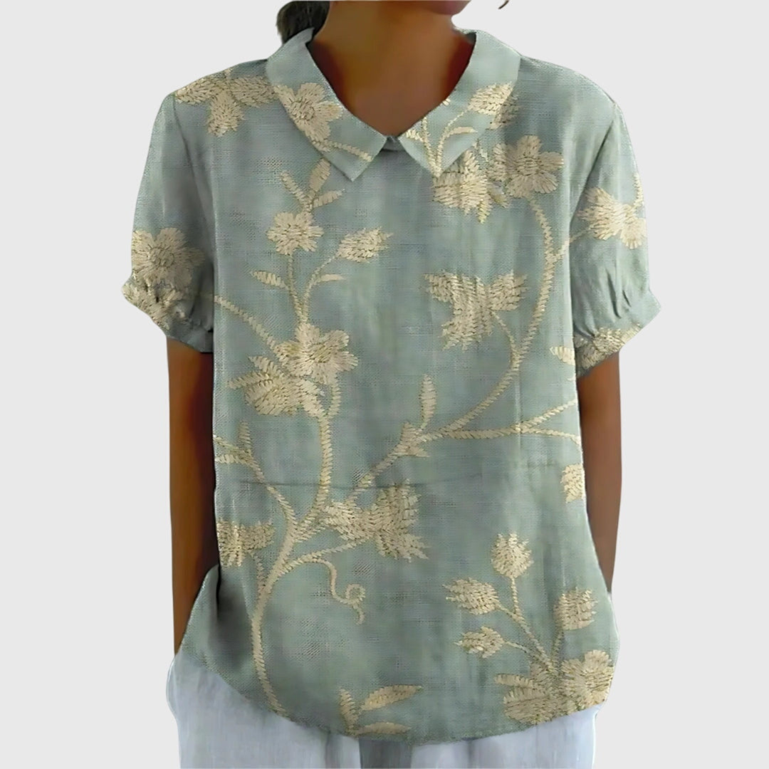 Professional yet relaxed floral print blouse for women. Short sleeve collared top, office wear ready.