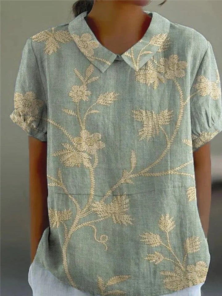 Women's floral print collared short sleeve blouse for casual summer wear. Relaxed fit stylish everyday fashion top.