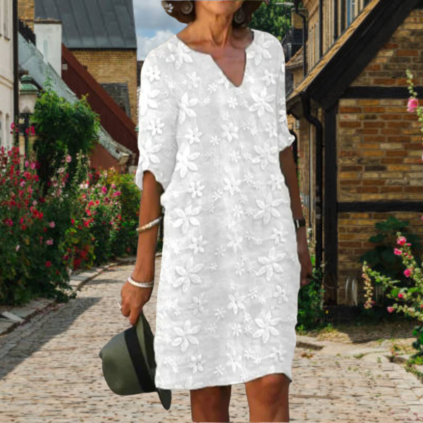 Women's floral V-neck midi dress with three-quarter sleeves and pockets, perfect for summer casual elegance.