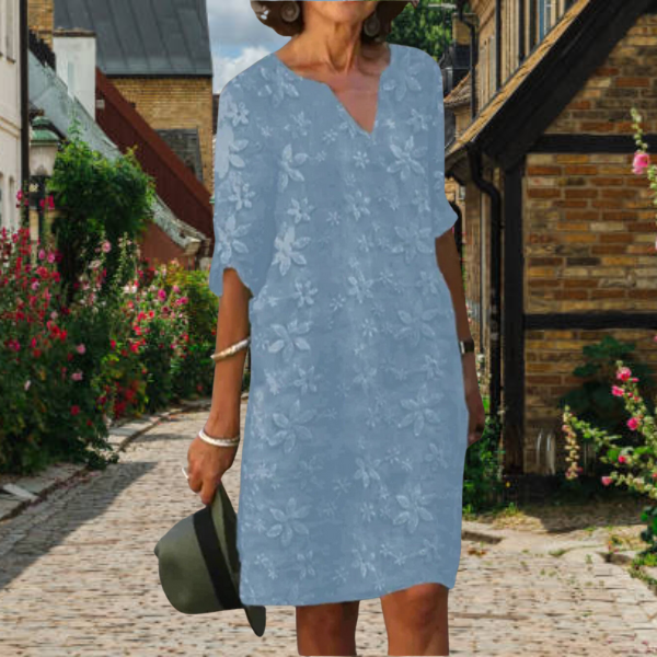 Chic women's spring/summer floral V-neck midi dress with three-quarter sleeves and functional side pockets.