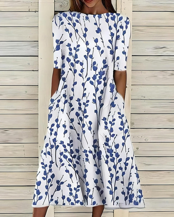 Women's flowy A-line midi dress with convenient pockets, perfect for casual summer wear. Features a comfortable style.