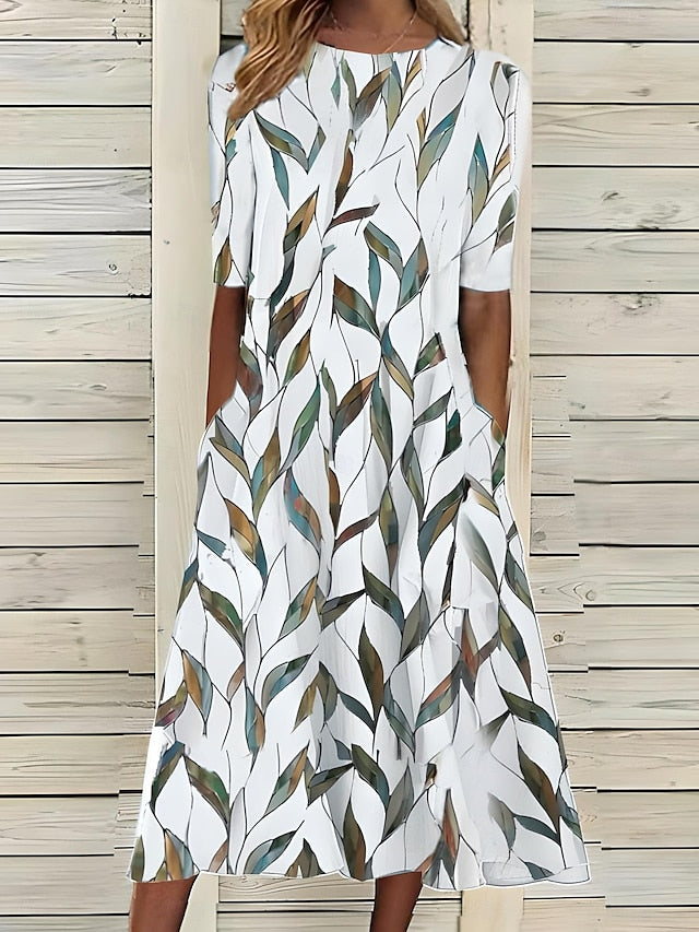 Comfortable women's A-line midi dress with an elegant botanical print and practical pockets, ideal for everyday summer.