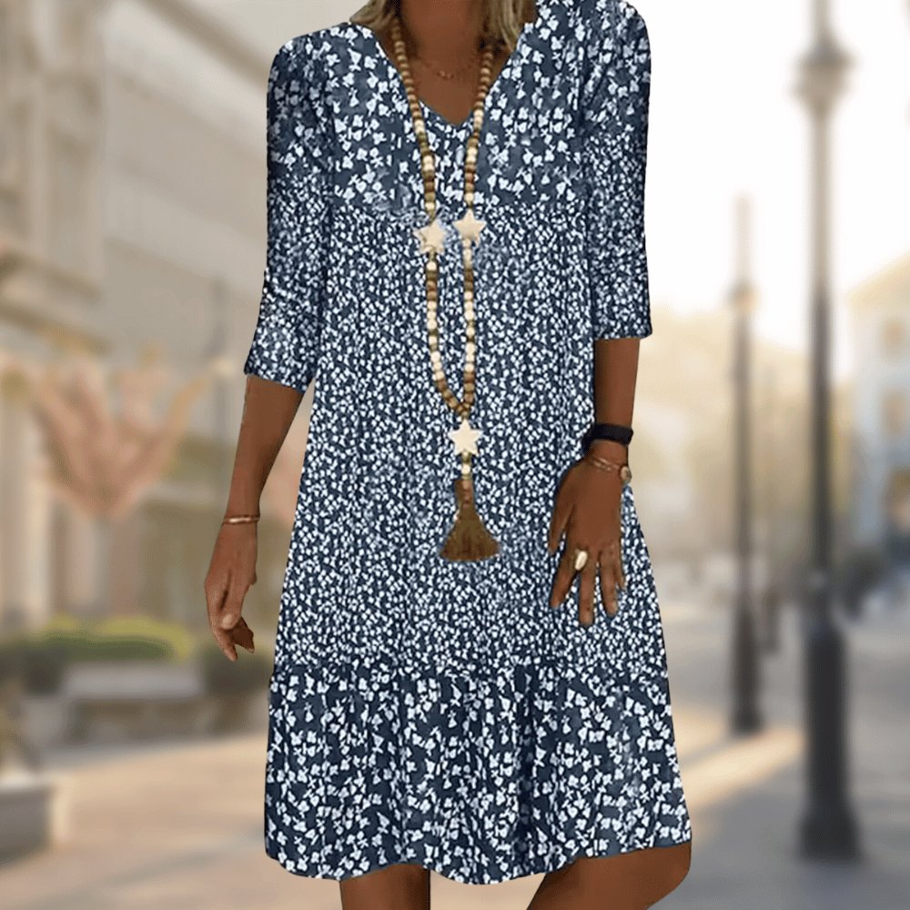 Women's flowy floral print tiered summer dress with V-neck, three-quarter sleeves, perfect for casual wear.