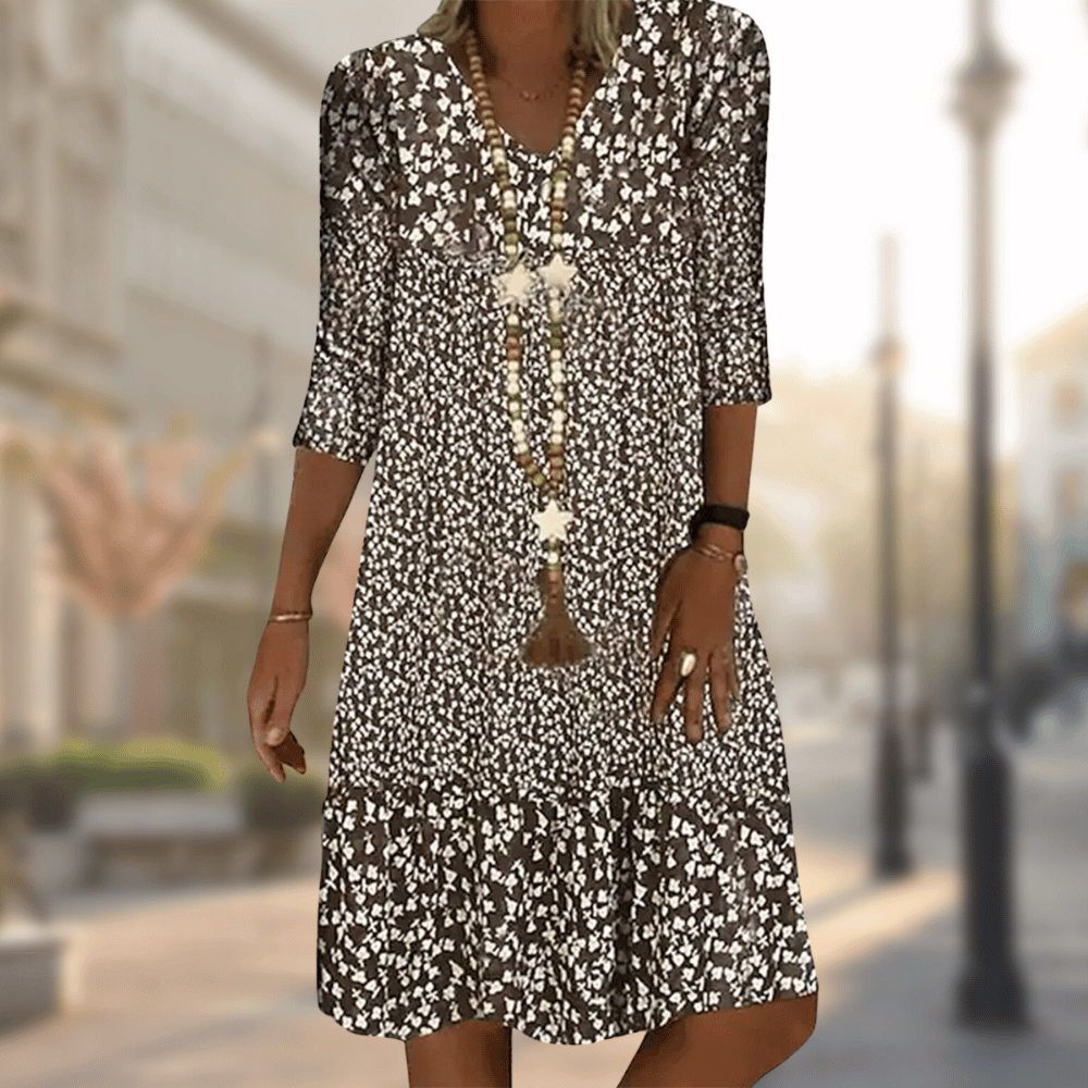 Casual women's tiered floral summer dress with flowy fabric, V-neck, and three-quarter sleeves for ultimate comfort.