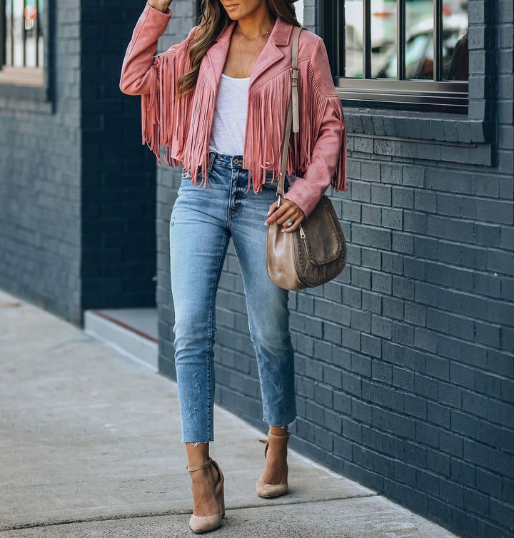 Woman wearing a black fringed suede motorcycle jacket, a statement piece for autumn fashion